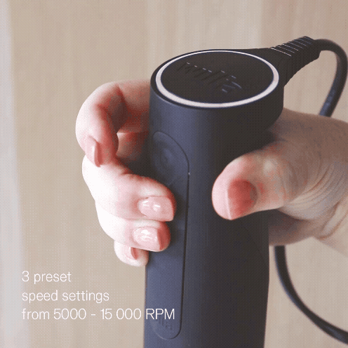 Close-up of a hand gripping the black Wilfa Prostick immersion blender handle, with the text '3 preset speed settings from 5000 to 15 000 RPM'.