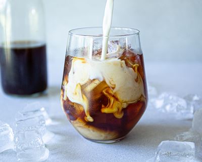 Glass of cold brew coffee with ice and milk