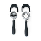 Two portafilter forks with portafilters attached, accessories for the Wilfa Uniform Evo coffee grinder, on a white background.
