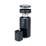 Exploded view of the Wilfa Uniform Evo coffee grinder showing the lid, bean hopper, burr assembly, body and grounds container stacked vertically.