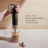 A hand using the Wilfa Prostick immersion blender in a small jug of sauce, with the text 'Small stick: ideal for precise blending and emulsions. Fits the small jug.'