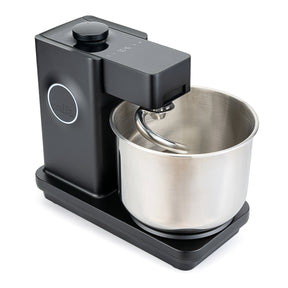 Wilfa Probaker NXT black stand mixer seen at an angle, with the stainless steel bowl and dough hook in place.